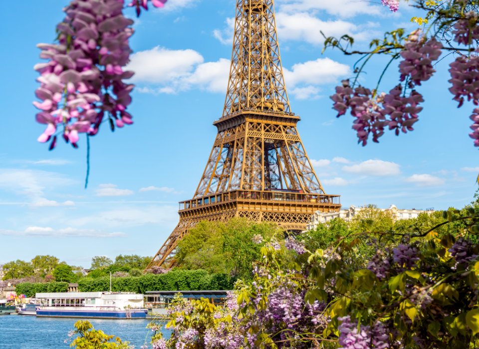 Image of a river cruise ship on the Seine in Paris with the Eiffel Tower in the distance